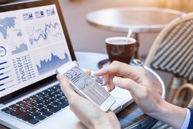 Businesswoman Analyzing Stock Market KPI With BI, Computer, Smartphone Screen
