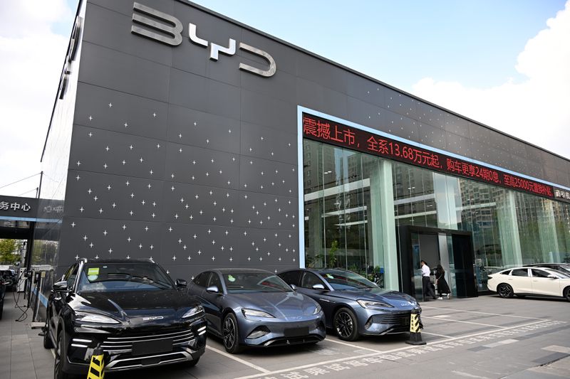 A group of black and silver electric vehicle sit outside a BYD store in China.