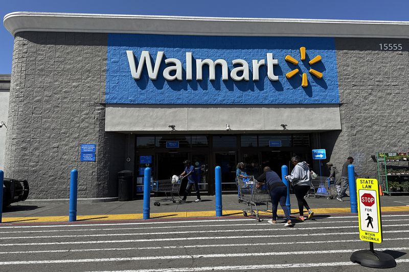 Customers enter a Walmart store on April 09, 2025 in San Leandro, California