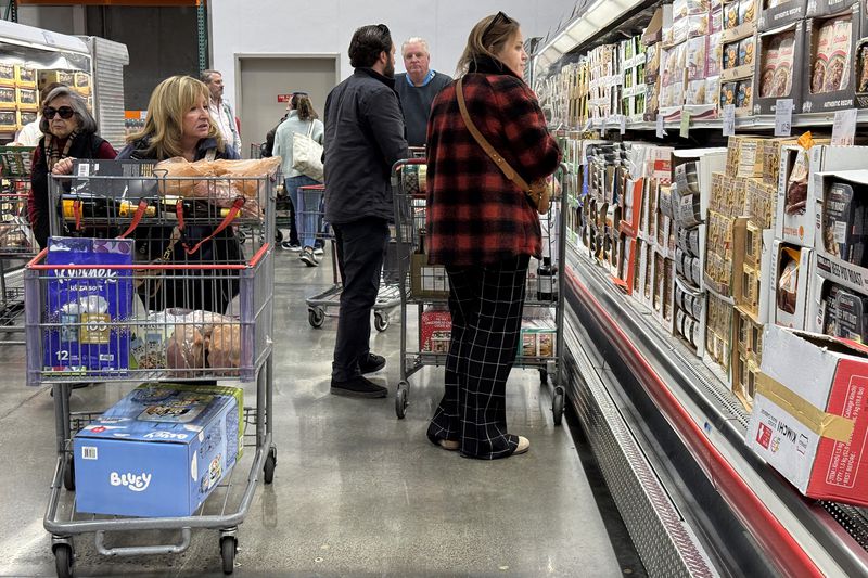 Customers shop for groceries at a Costco store in Novato, California