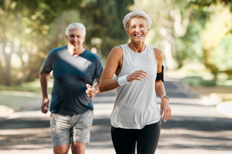 Two middle-aged people running outdoors