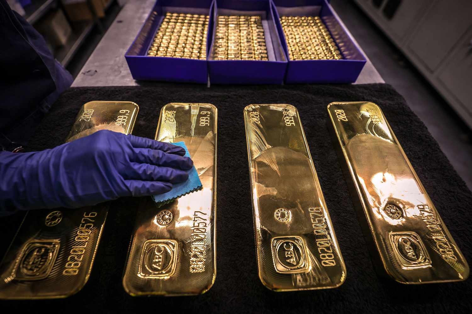 A worker polishes gold bullion bars