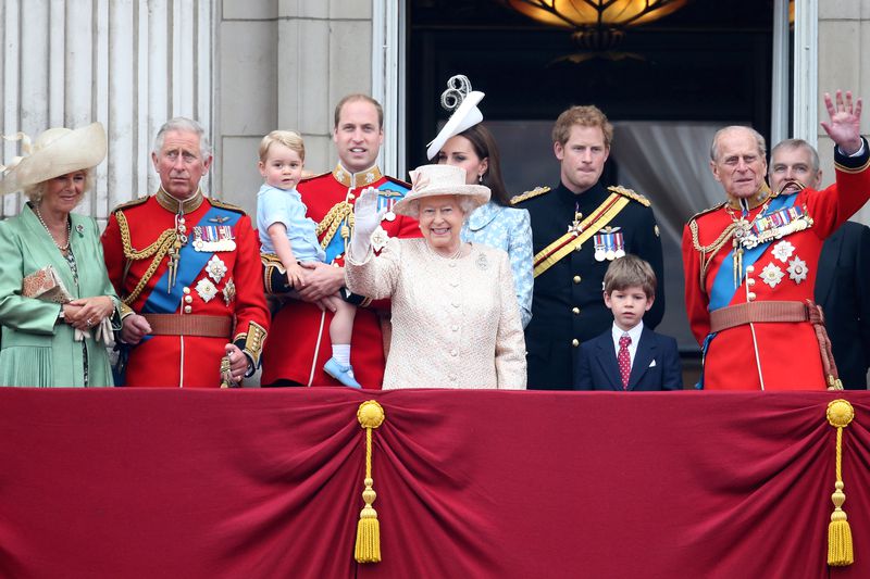 The British Royal Family wave at a crowd from the balcony of Buckingham Palace
