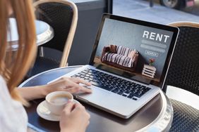 A laptop that says rent on the screen