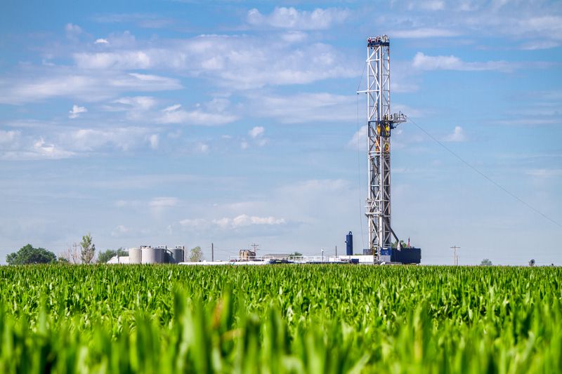 Oil rig on a corn field.