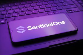 SentinelOne logo on a smartphone screen, sitting on a laptop.