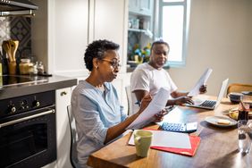 Senior couple going over their finances at the kitchen table