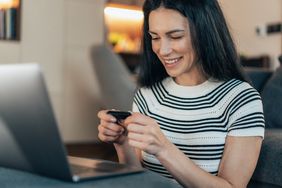 A woman using hard wallet for storing cryptocurrency.
