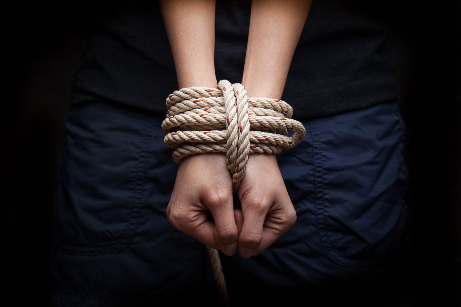 Hands with rope around them