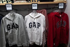 A gray, white, and red Gap sweatshirt are seen on display at a Gap store.
