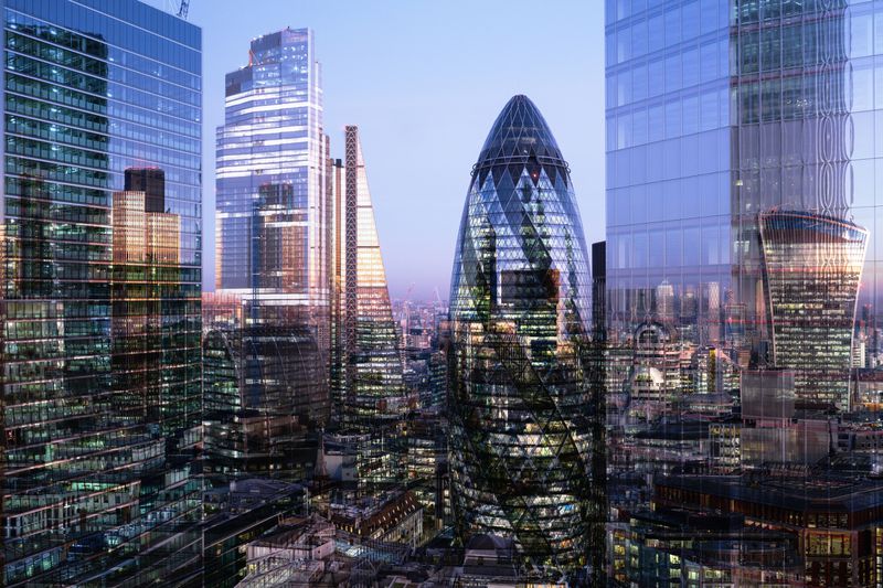 U.K., London, multiple-exposure, elevated view of high-rise financial buildings in the city, illuminated at dusk