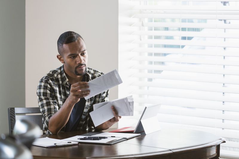 A man sifts through bills.