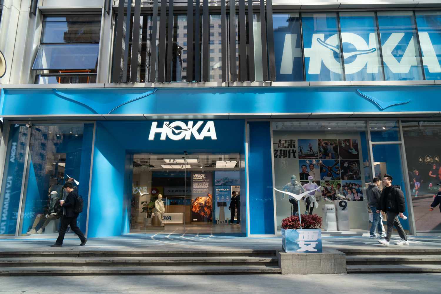 Pedestrians pass a HOKA store in Shanghai, China, on February 18, 2025. 