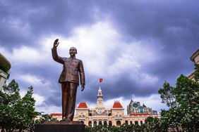 The statue of Ho Chi Minh in Ho Chi Minh City, Vietnam. In the background is the town hall building.