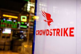 The red CrowdStrike logo is seen on a white screen on the floor of the New York Stock Exchange.