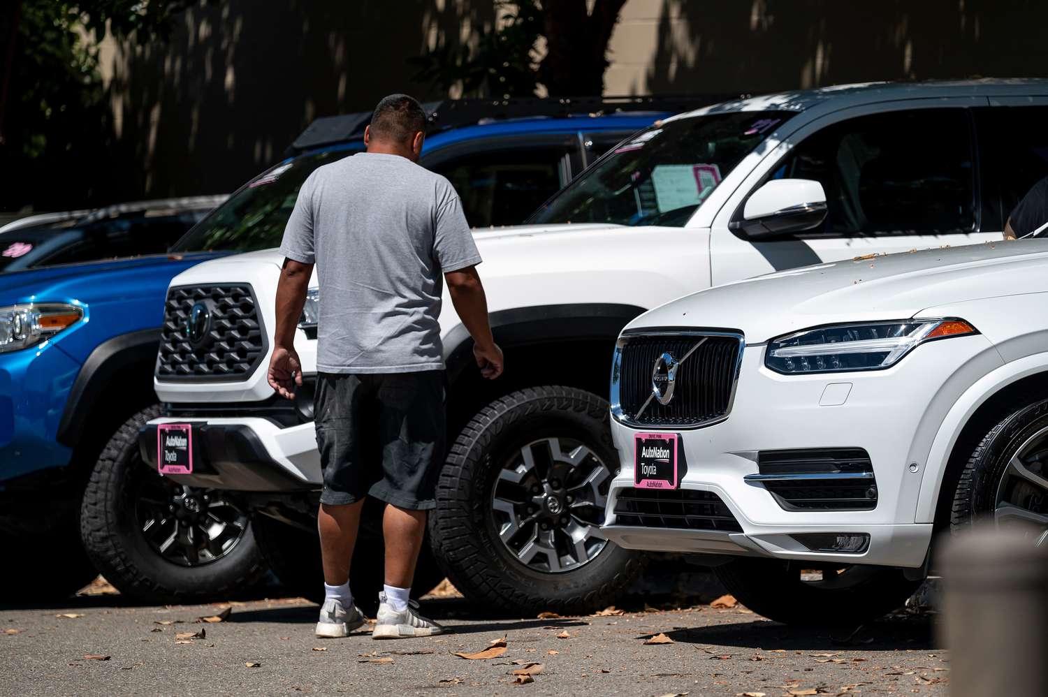A customer looks at vehicles for sale at an AutoNation Toyota dealership in Hayward, California, US, on Monday, June 24, 2024. 
