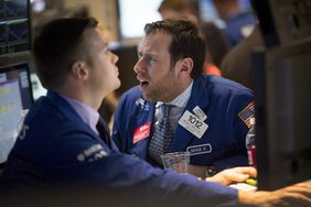 Two traders on the floor of the New York Stock Exchange
