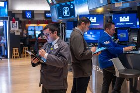 Traders work on the floor of the New York Stock Exchange