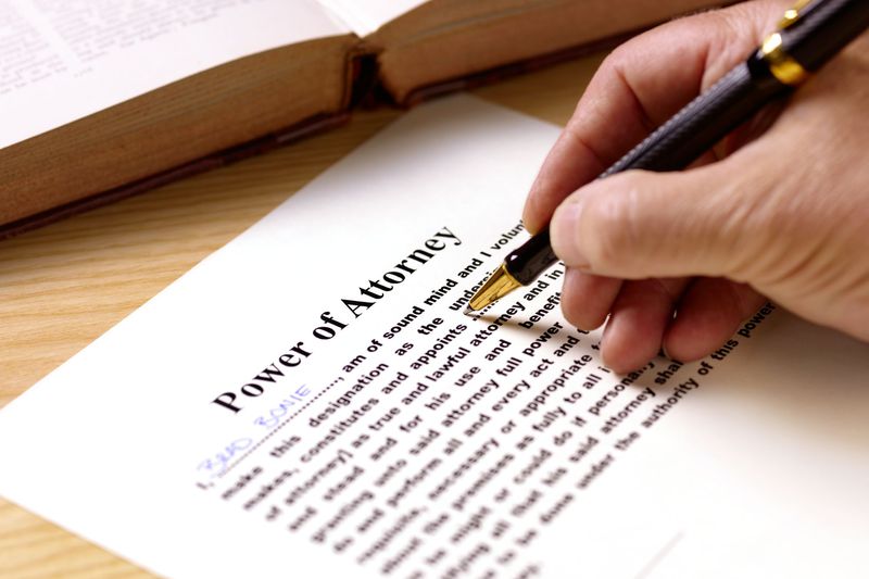 A person signing a power of attorney form