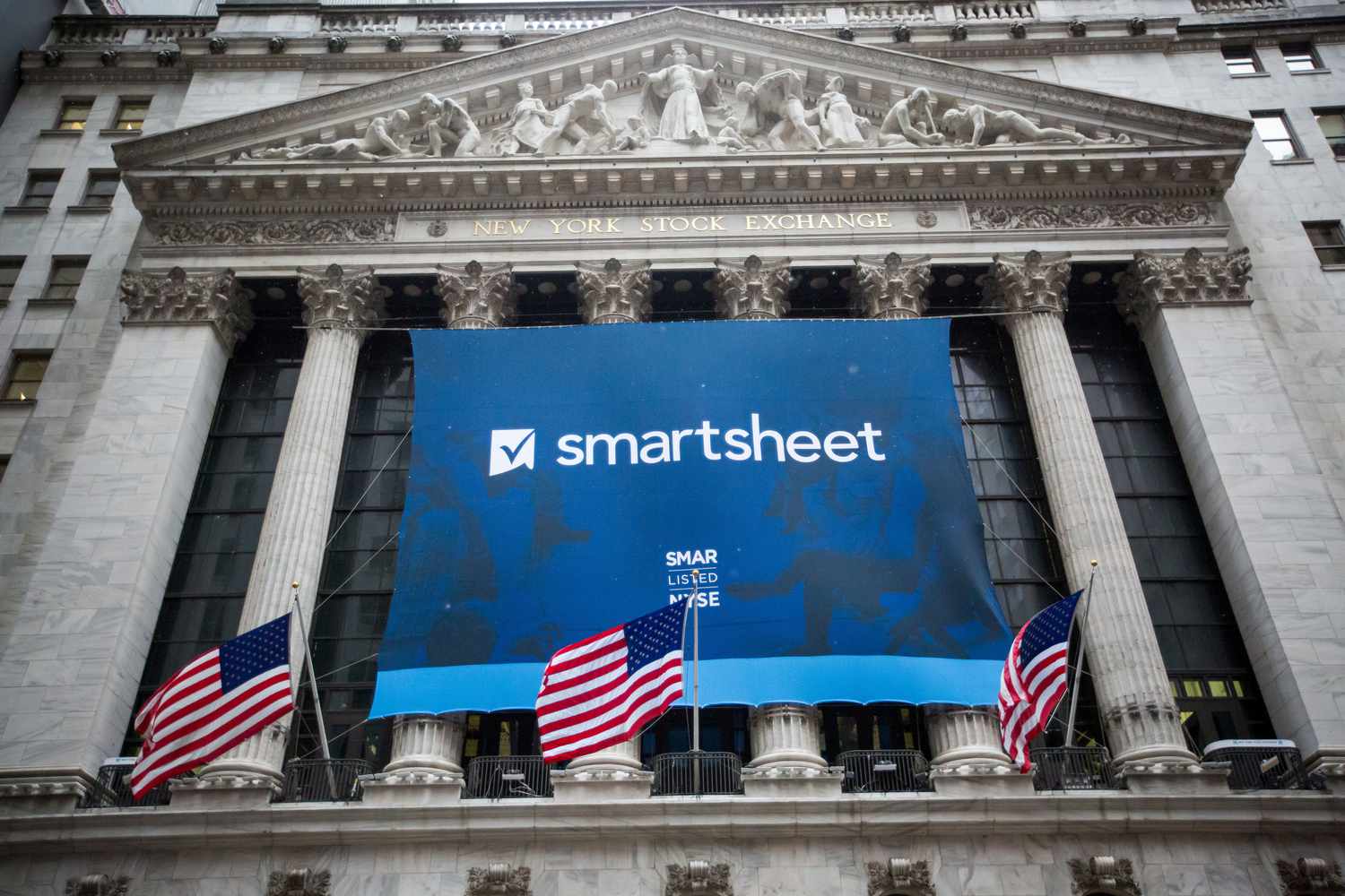 A Smartsheet banner is displayed during the company's initial public offering at the New York Stock Exchange in April 2018