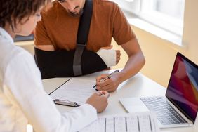 Patient is instructed by doctor to make an x-mark signature due to broken right hand. 