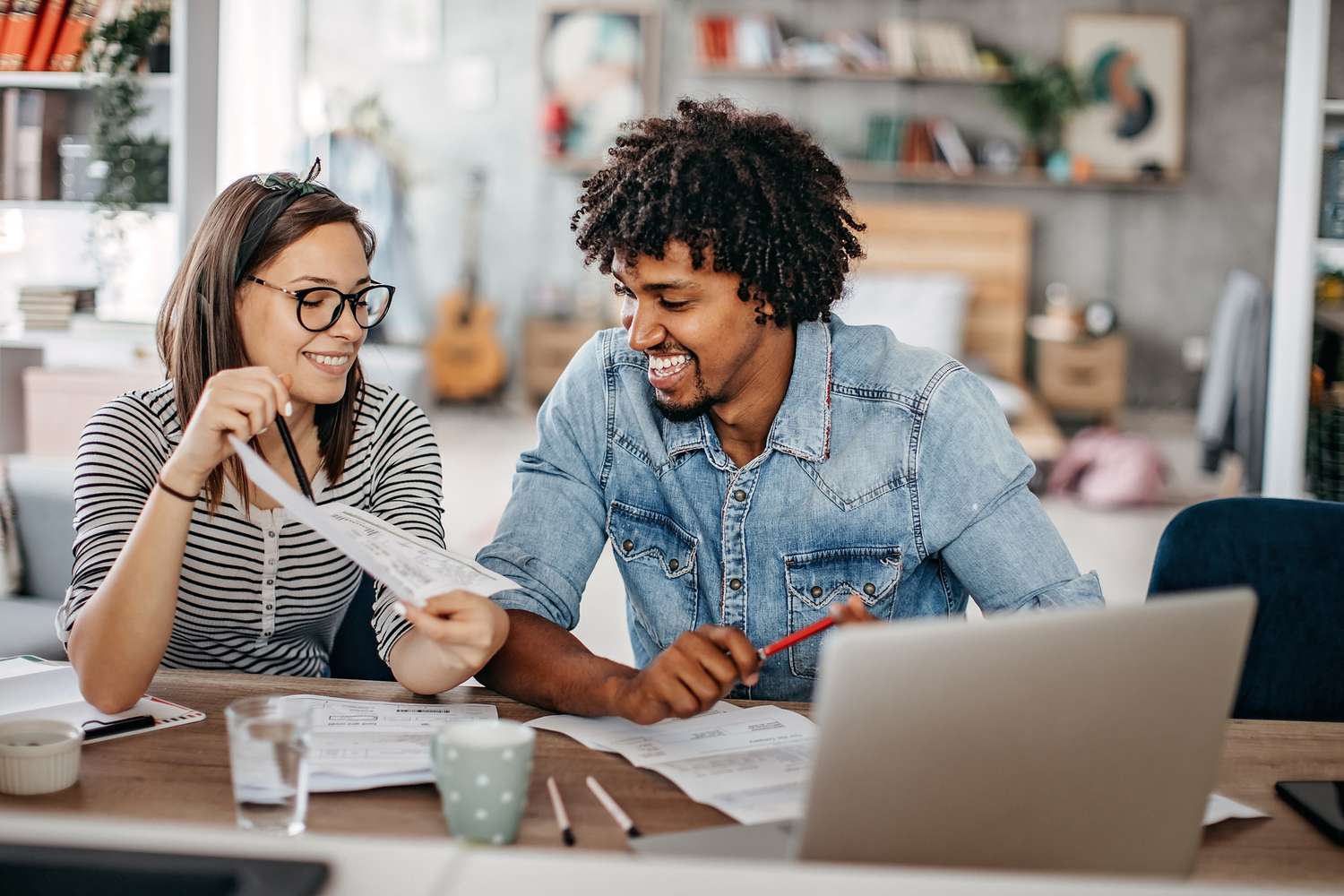 Young couple calculates monthly expenses at home