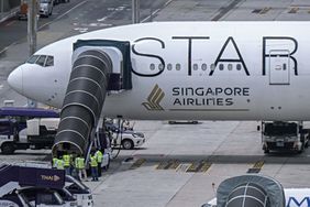 Officials in Bangkok, Thailand, enter the Singapore Airlines Boeing 777-300ER airplane that was headed to Singapore from London before making an emergency landing due to severe turbulence on May 22, 2024