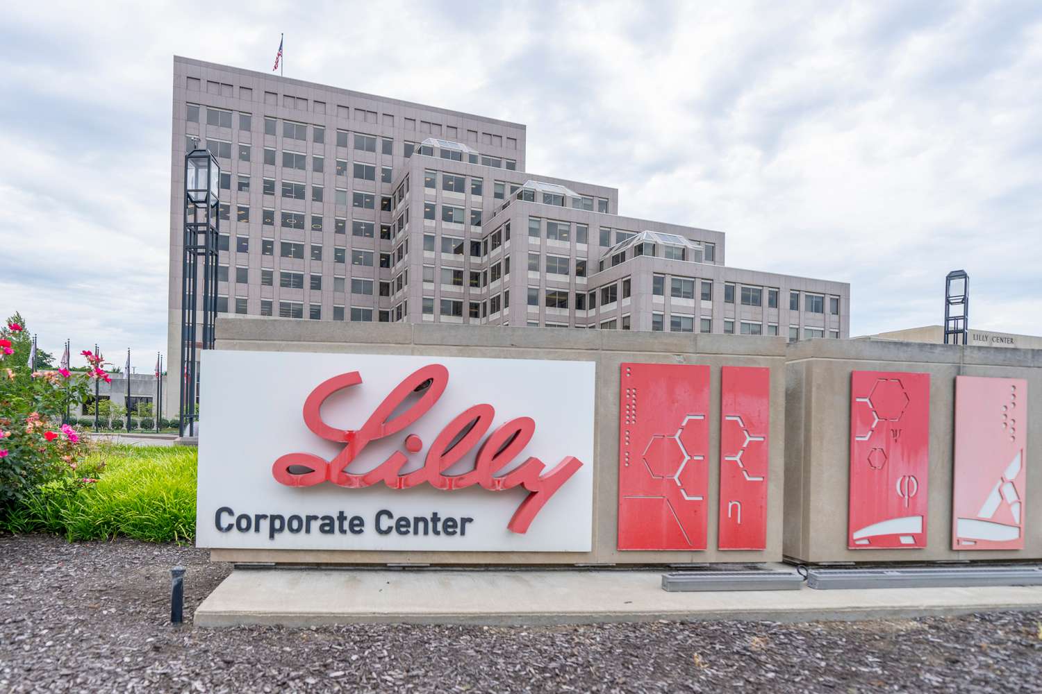 A sign for the Eli Lilly Corporate Center is seen outside a brown office building.