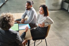 A couple talking with a financial advisor.