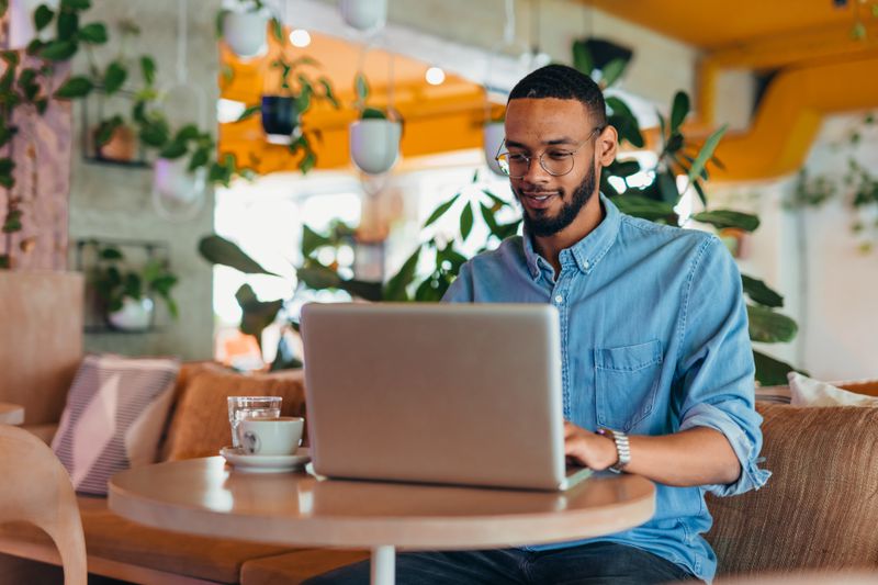 A man at home researching the best online stock trading classes