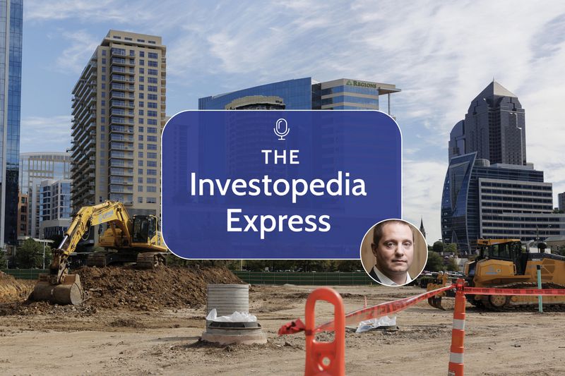 Image of bulldozers at a construction site in front of tall buildings 