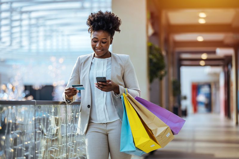 Woman Holds Shopping Bags in Mall