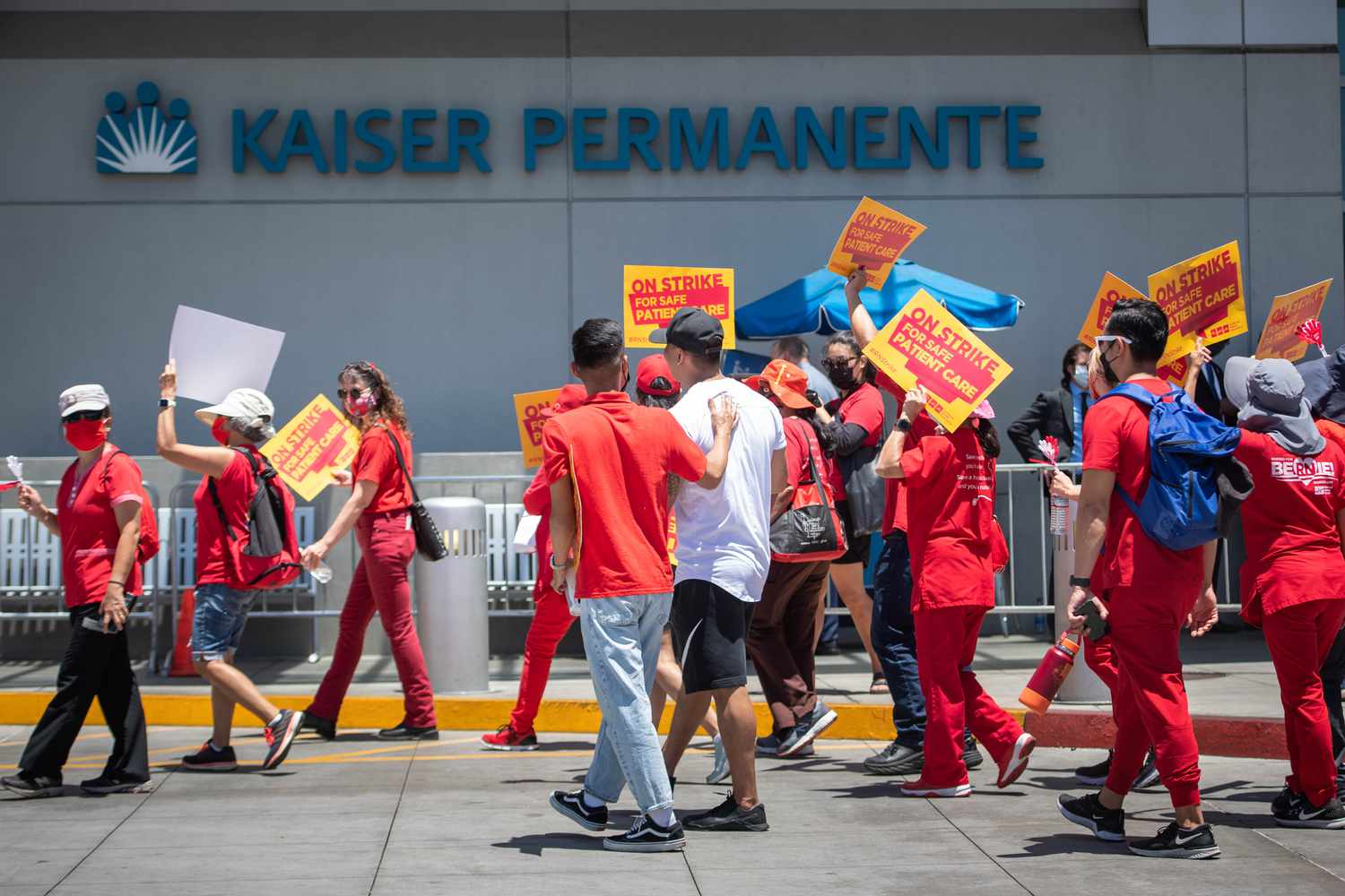 Health care workers picket outside of a Kaiser Permanente facility. 