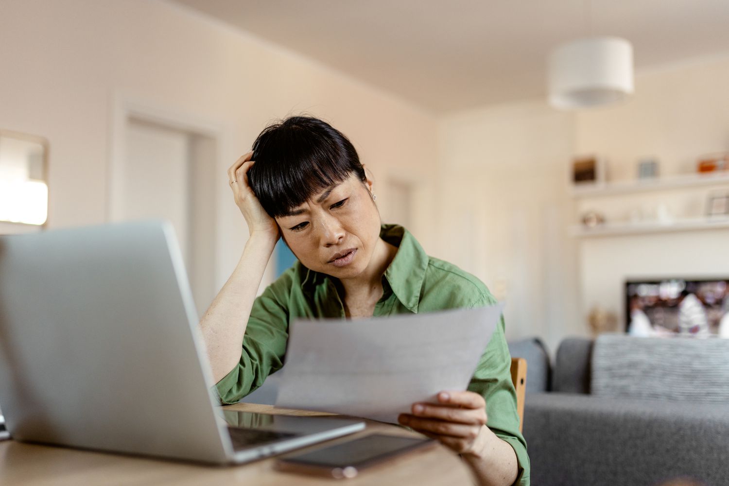 Woman reading about why and how her student loan creditors can garnish her money 
