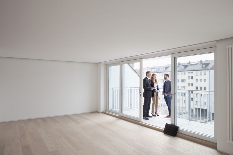 Young couple viewing flat with estate agent