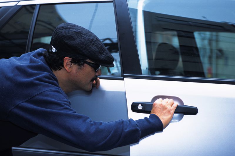 Man breaking into a vehicle