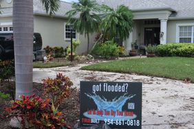 A sign for a water restoration company is seen in front of a home in the Laurel Meadows neighborhood which was flooded by rains from Tropical Storm Debby on August 10, 2024 in Sarasota, Florida.