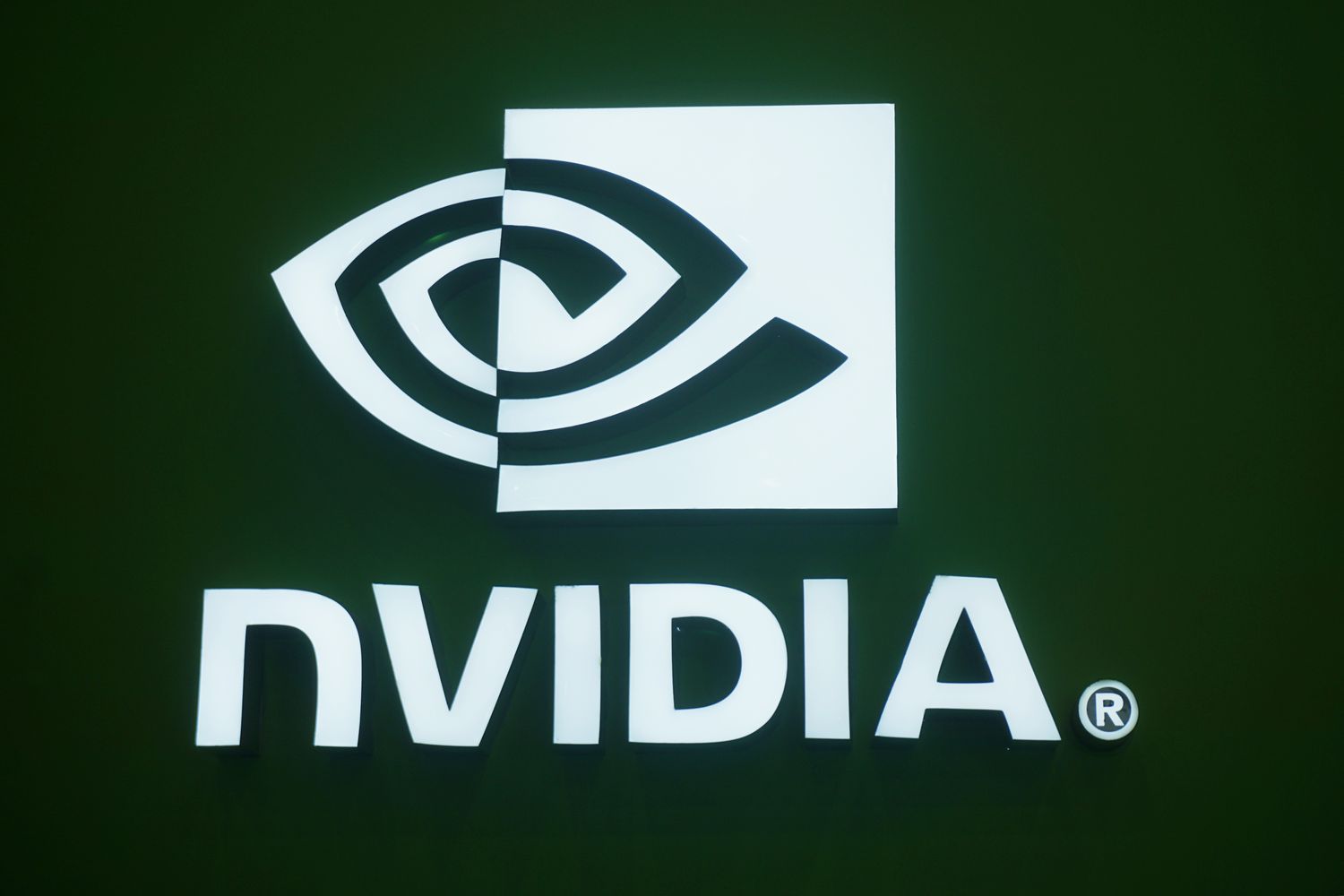 The Nvidia logo is displayed at a tech conference. 