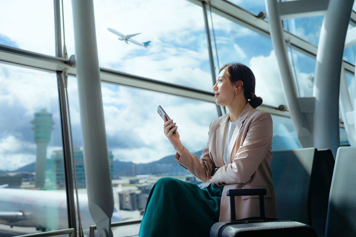 Person checking prices on a cell phone in an airport.