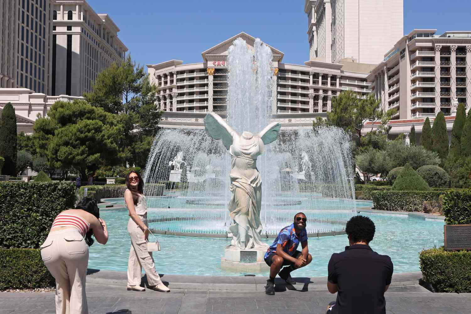 Tourists take photos outside Caesars Palace hotel and casino in Las Vegas
