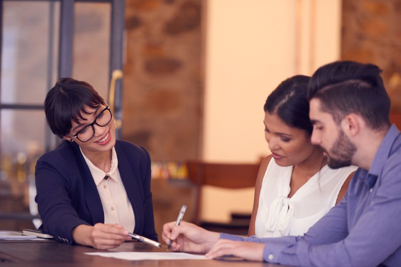 couple sitting with insurance advisor