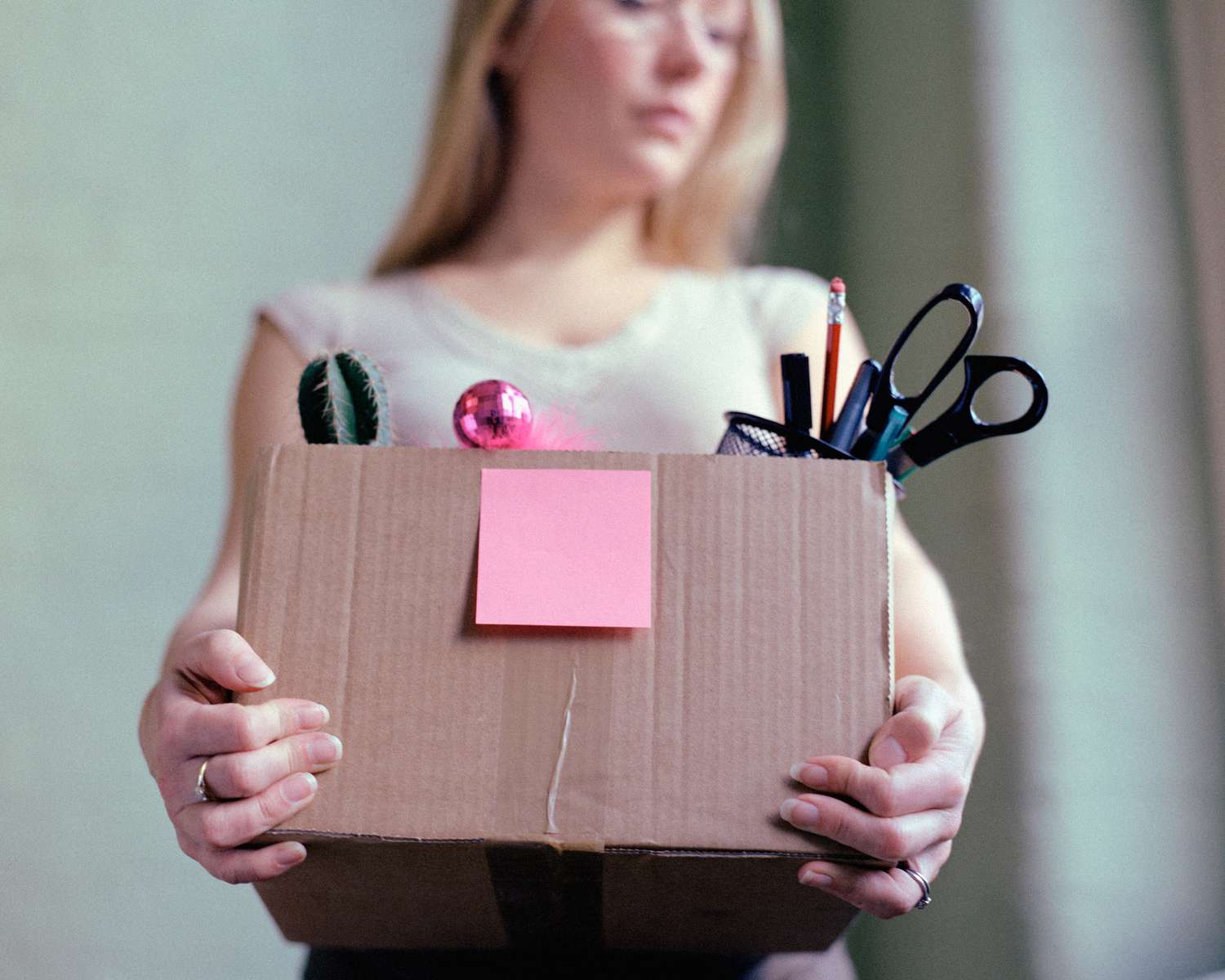 Woman holding a box of her office supplies.