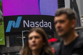 People walk near the Nasdaq's building in Times Square 