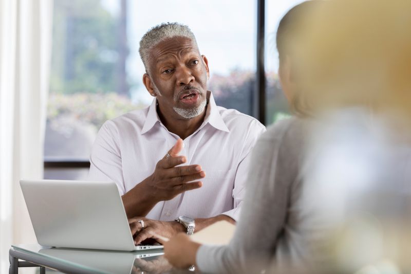 Banker discussing with a prospective client why they should consider switching to their institution