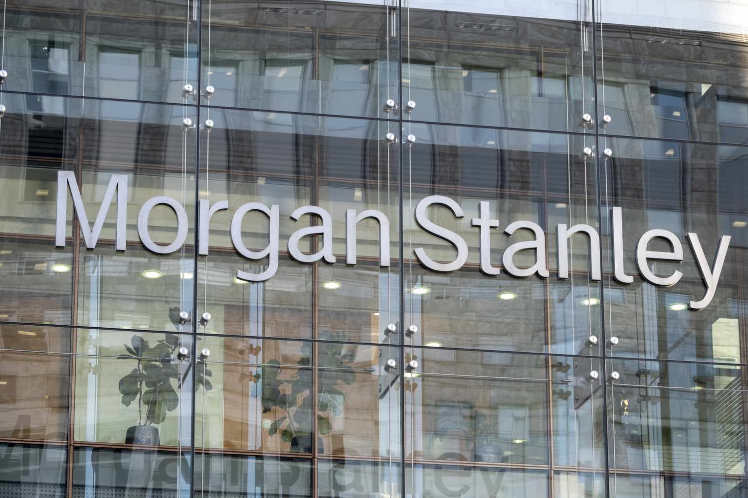 The gray Morgan Stanley logo is seen on the side of a glass office building.
