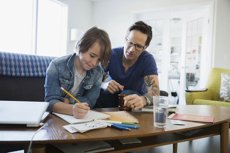 Kid working on homework with parent