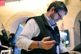 Trader looking down at his tablet