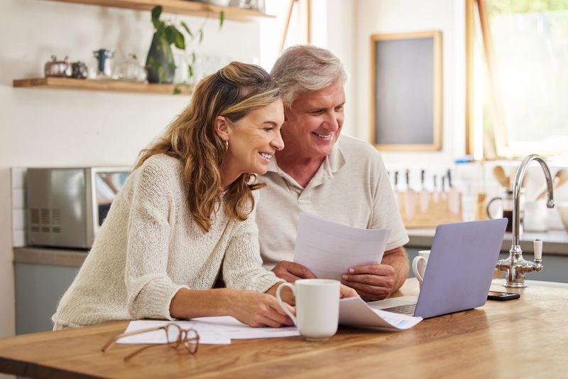 Older couple at home with a computer