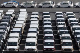 Toyota trucks awaiting shipment are parked at a port on March 27, 2025 in Yokohama, Japan