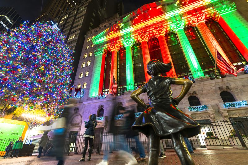 New York Stock Exchange Building and Big Christmas tree glows in Christmas colors and decorated with Christmas decorations in the night at Lower Manhattan New York City NY on Jan. 01 2020. 
